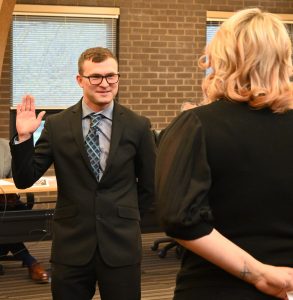 Officer Jeffrey Cook recites the Oath of Office with Village Clerk Jessi Watkins.