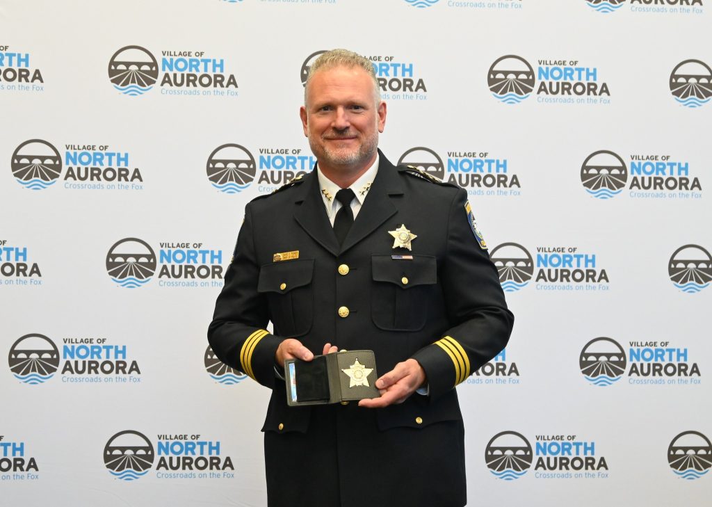 Chief David Fisher with his retired badge.