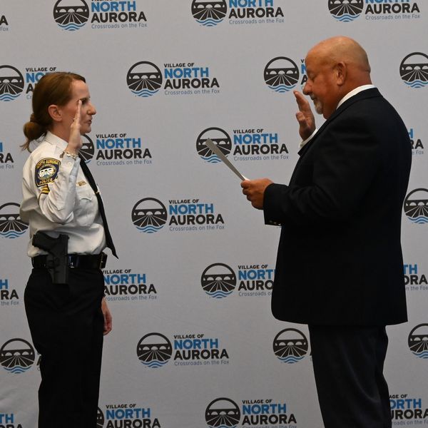 Newly sworn in Sergeant Kristen Lohrstorfer (L) and Mayor Mark Gaffino.