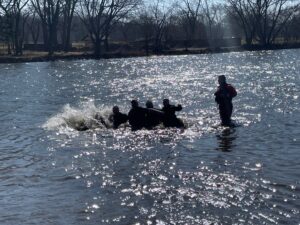 Officers plunging in water
